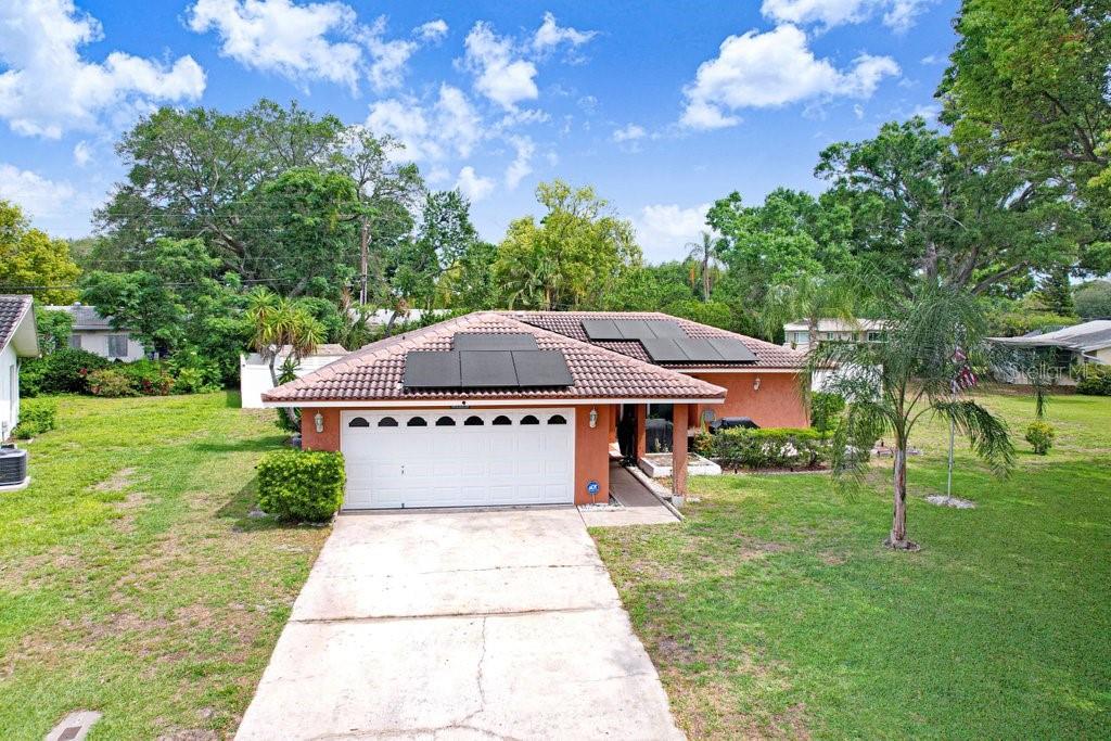 1632 Heather Place Palm Harbor, FL 34684 - Photo 2 of 53 a front view of a house with a yard