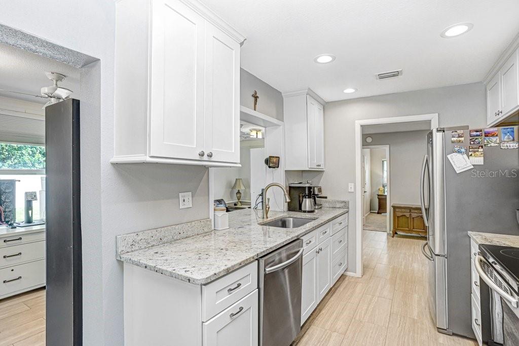 1632 Heather Place Palm Harbor, FL 34684 - Photo 31 of 53 a kitchen with a sink stove and cabinets