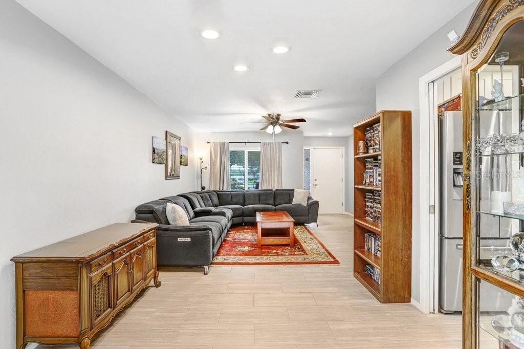 1632 Heather Place Palm Harbor, FL 34684 - Photo 36 of 53 a living room with furniture flat screen tv and a table