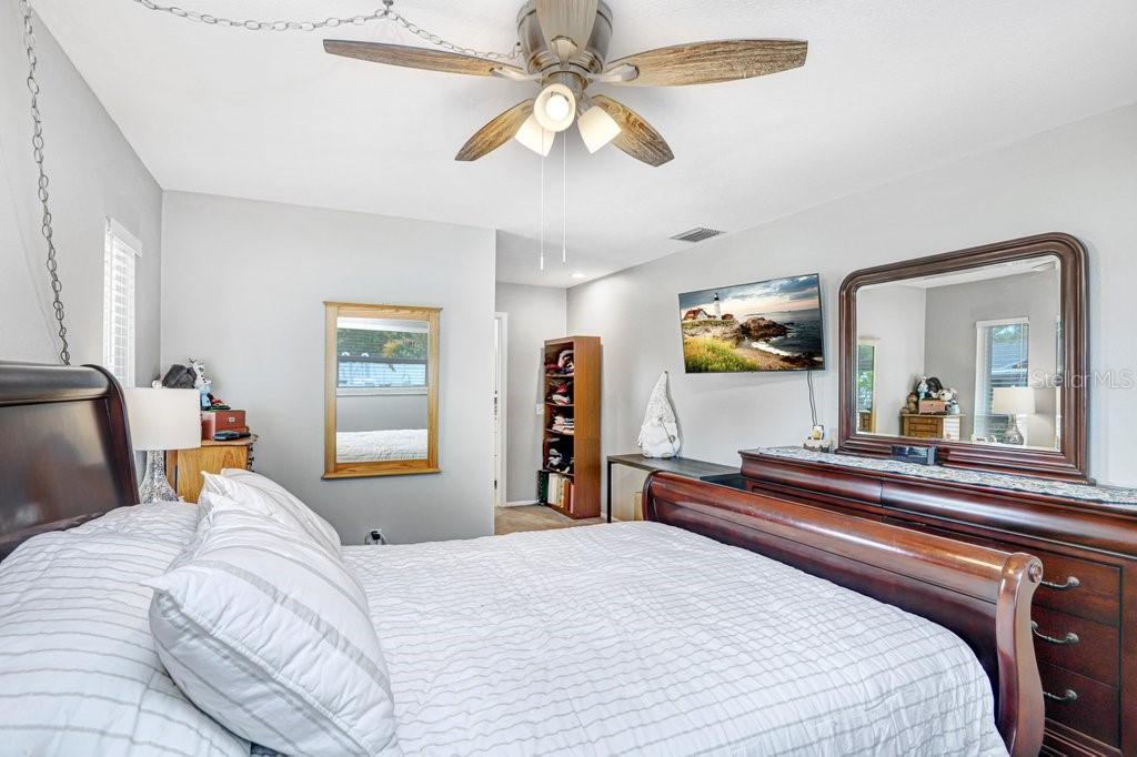 1632 Heather Place Palm Harbor, FL 34684 - Photo 39 of 53 a bedroom with a bed and a dresser with mirror