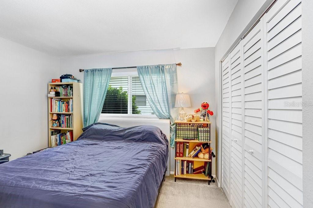 1632 Heather Place Palm Harbor, FL 34684 - Photo 43 of 53 a bed sitting in a bedroom next to a window