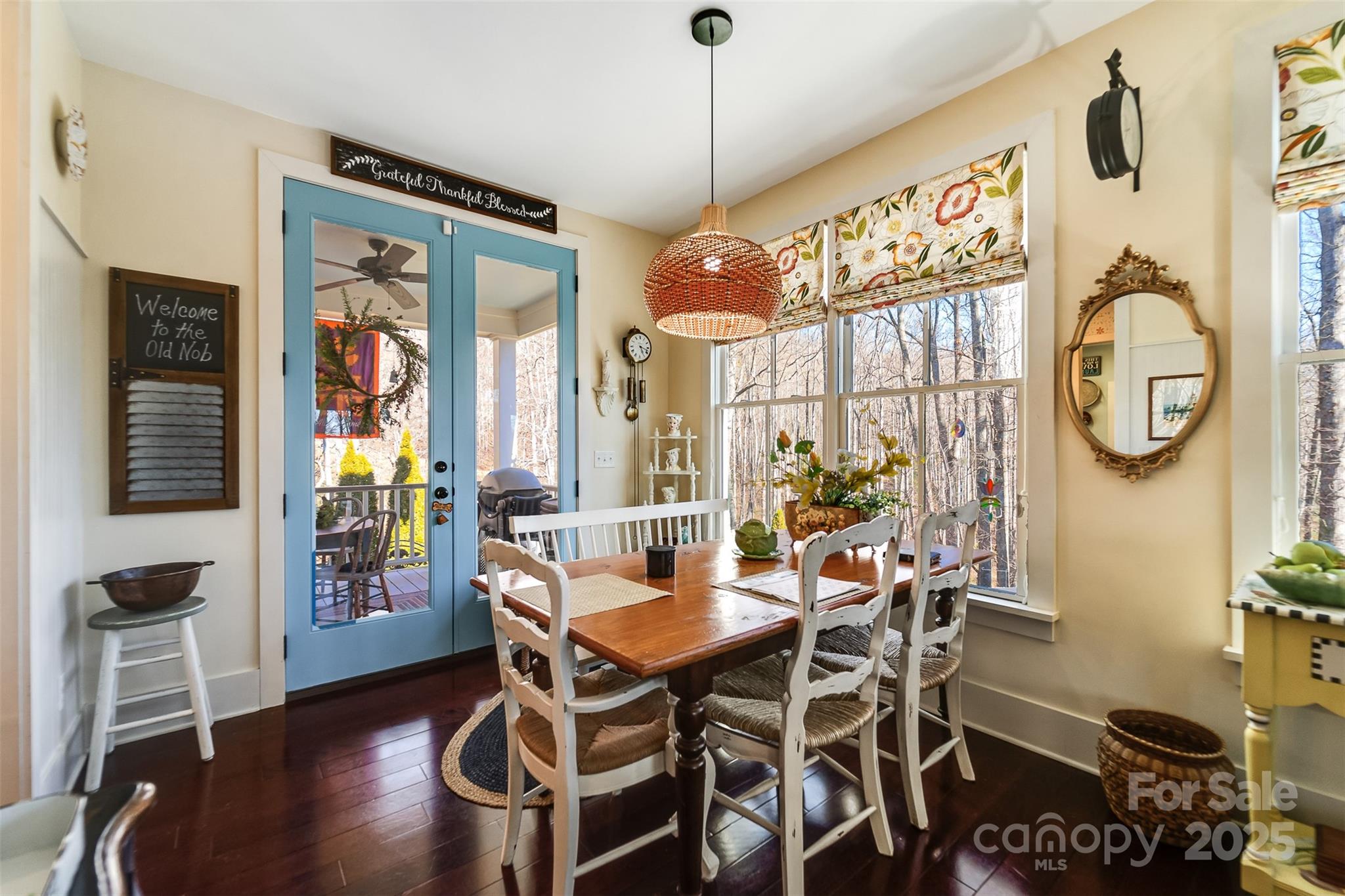 1226 Monteith Branch Road Sylva, NC 28779 - Photo 21 of 40 a dining room with furniture a chandelier and wooden floor