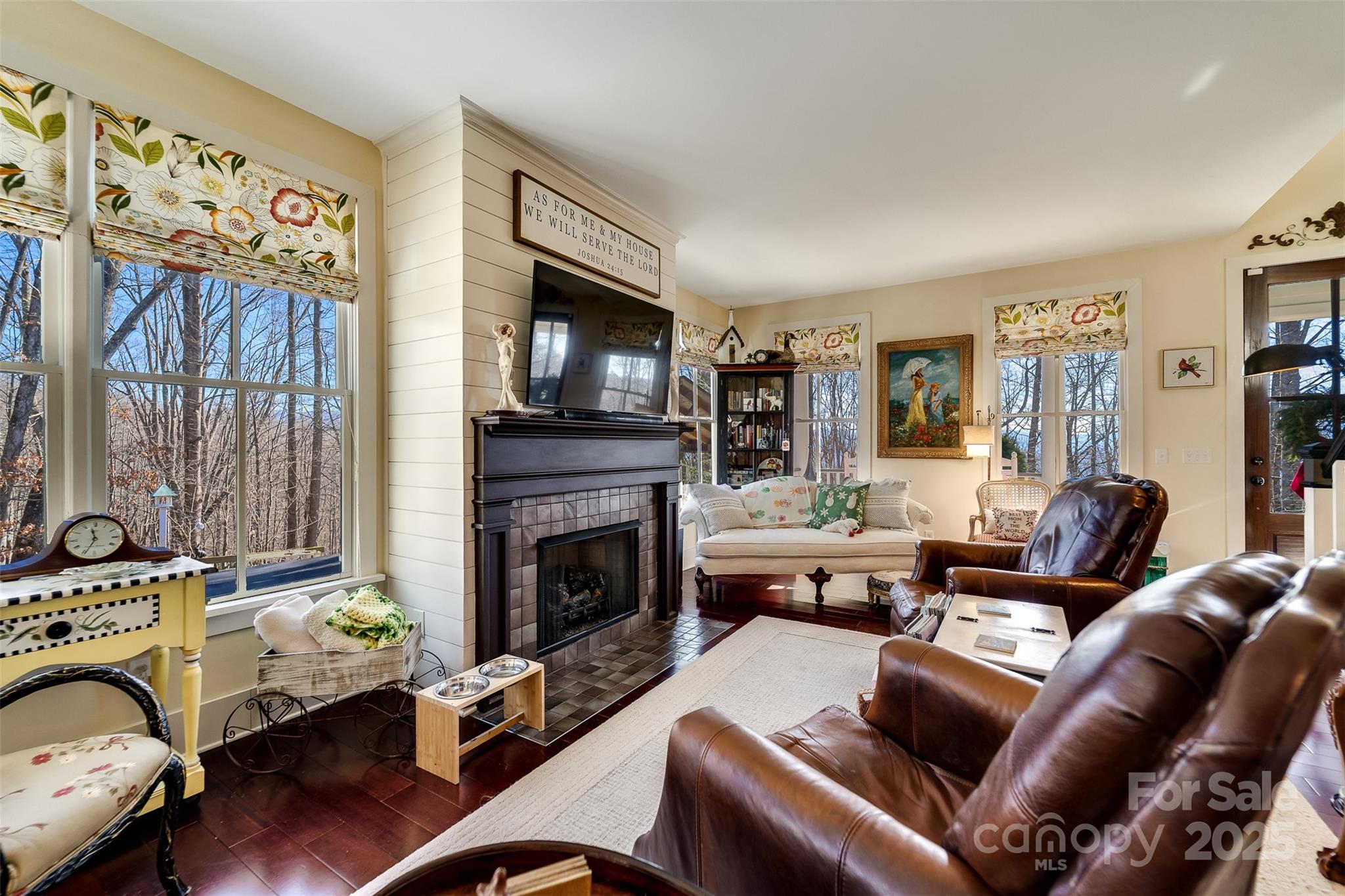 1226 Monteith Branch Road Sylva, NC 28779 - Photo 28 of 40 a living room with furniture large window and a fireplace