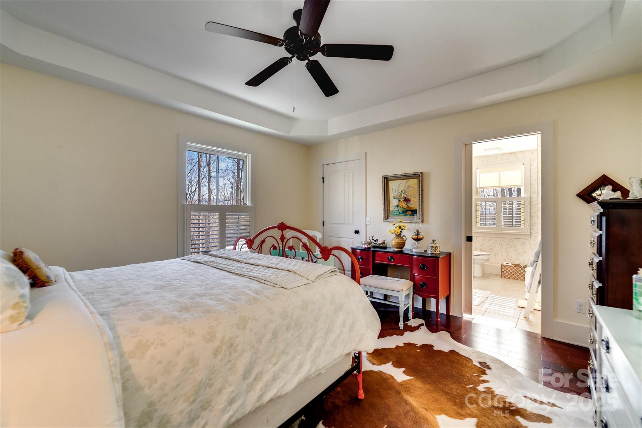1226 Monteith Branch Road Sylva, NC 28779 - Photo 39 of 40 a bedroom with a bed and wooden floor