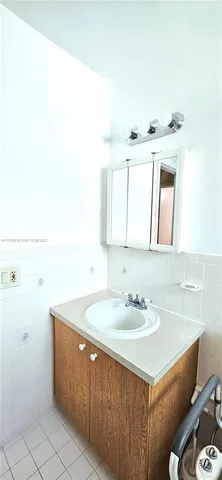 a bathroom with a sink vanity and a mirror