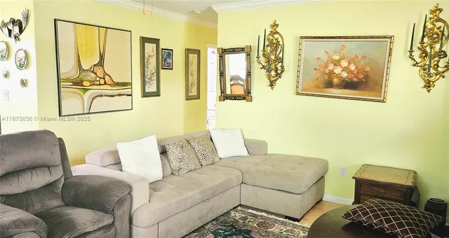 a living room with furniture and a painting on the wall