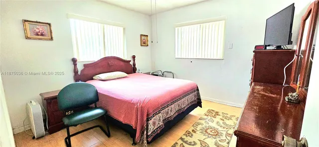 a bedroom with a bed and a chair