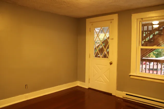a view of front door with wooden floor