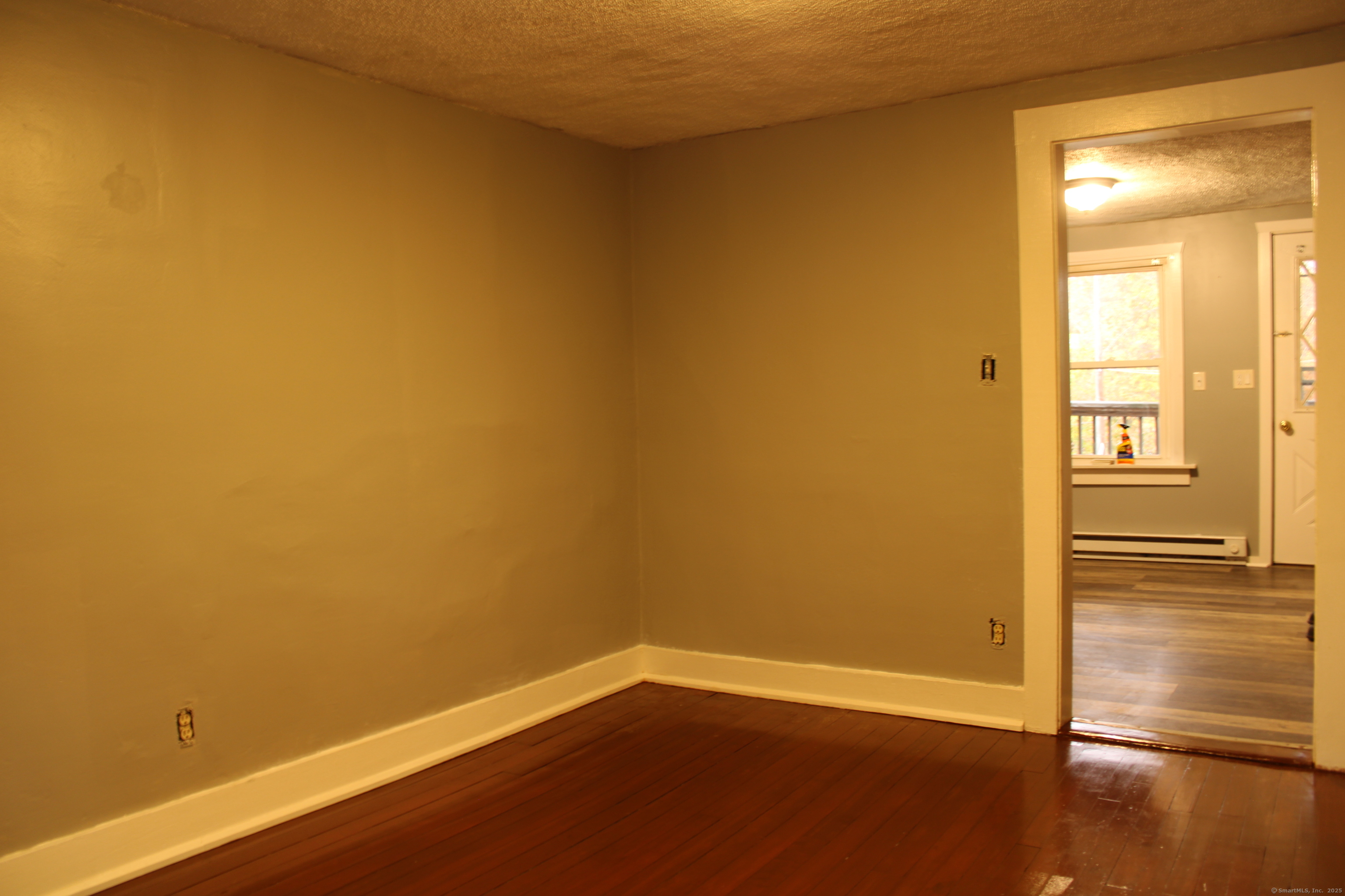 24 James Street Bristol, CT 06010 - Photo 5 of 12 an empty room with wooden floor and windows