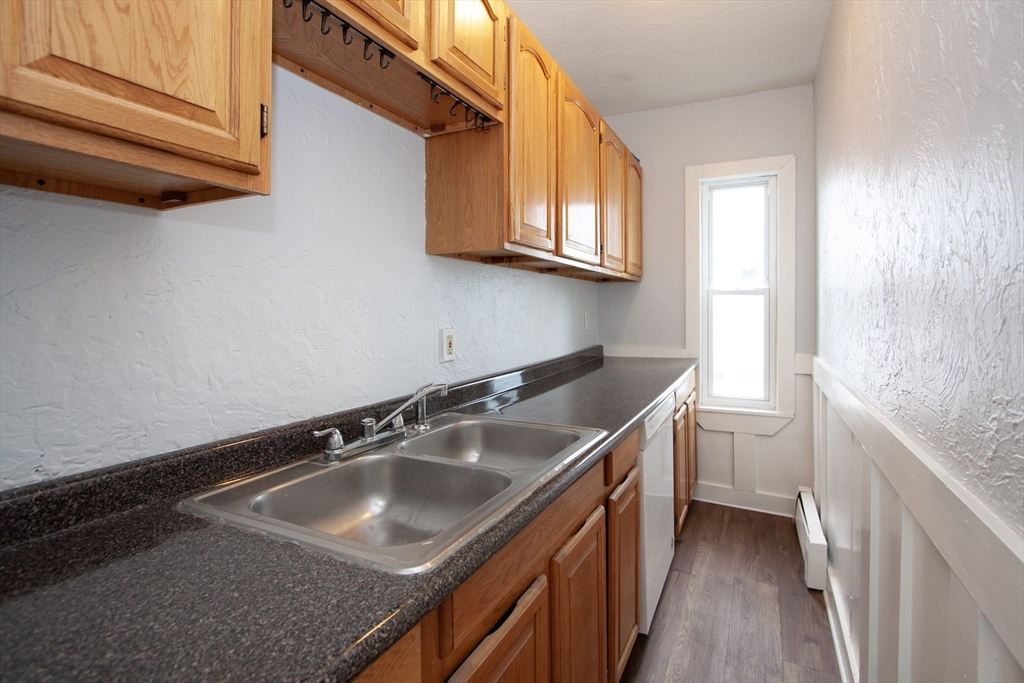 66 Cutler Street Worcester, MA 01604 - Photo 7 of 27 a kitchen with a sink cabinets and a window