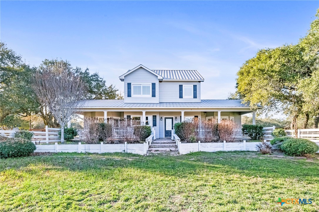 3052 Charco Road Nordheim, TX 78141 - Photo 14 of 43 a front view of a house with garden