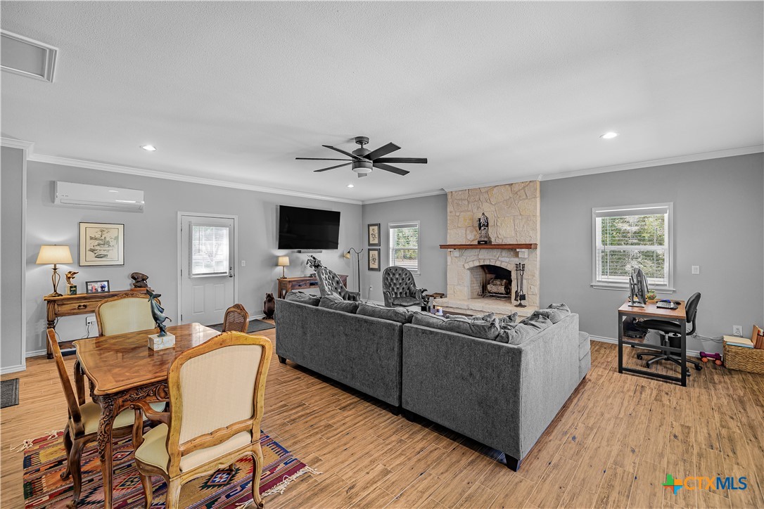 3052 Charco Road Nordheim, TX 78141 - Photo 20 of 43 a living room with furniture a fireplace and a flat screen tv