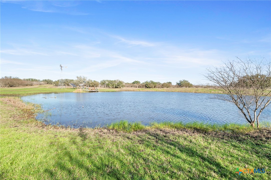 3052 Charco Road Nordheim, TX 78141 - Photo 2 of 43 a view of a lake with houses in the back