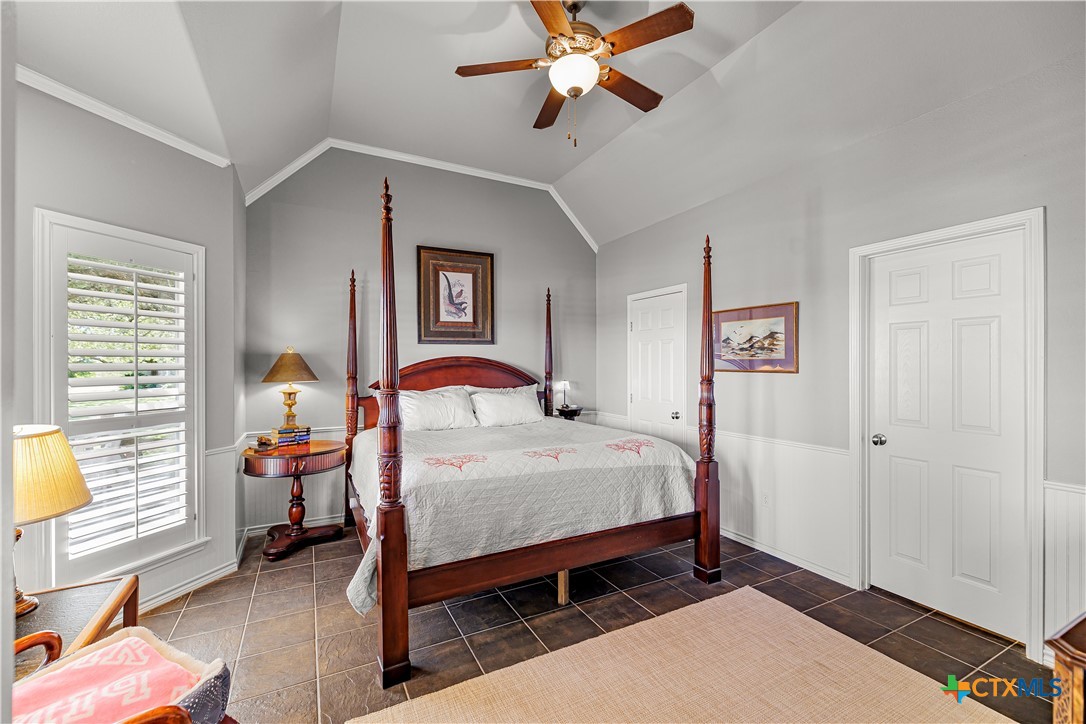 3052 Charco Road Nordheim, TX 78141 - Photo 21 of 43 a bedroom with a bed and a chandelier