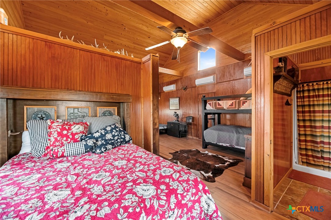 3052 Charco Road Nordheim, TX 78141 - Photo 42 of 43 a bedroom with a bed and wooden floor