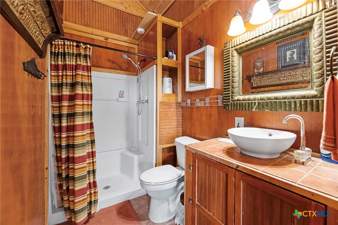 3052 Charco Road Nordheim, TX 78141 - Photo 43 of 43 a bathroom with a sink toilet and shower