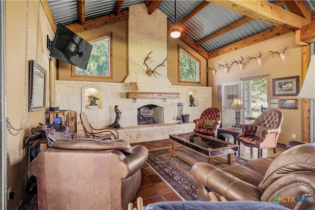 a living room with furniture a fireplace and a table