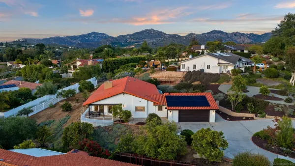 an aerial view of residential houses with outdoor space and street view