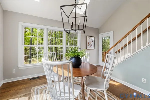 a view of a dining room with furniture window and wooden floor