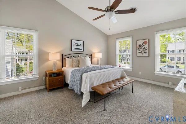 a spacious bedroom with a bed and a window