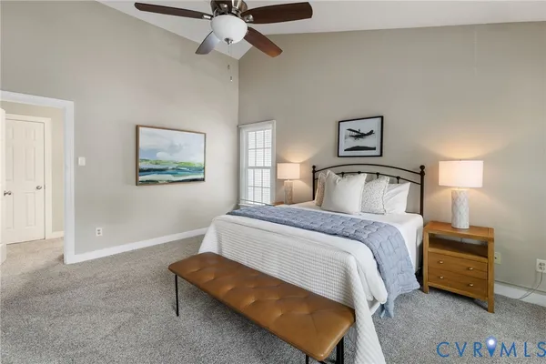 a bedroom with a bed and ceiling fan
