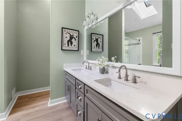 a bathroom with a sink mirror and vanity