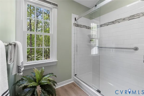 a bathroom with a shower and a window