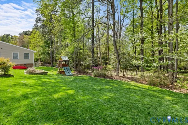 a view of an house with backyard space and garden