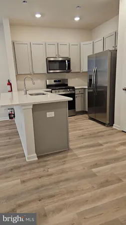 a view of kitchen and empty room