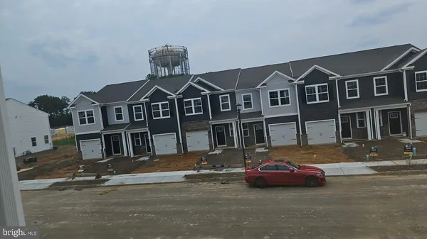 a kitchen with stainless steel appliances a sink a microwave a refrigerator and cabinets