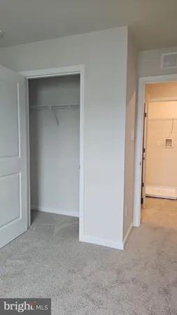 a view of a room with rack on the wall and a window