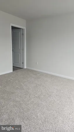 an empty room with a empty space and windows