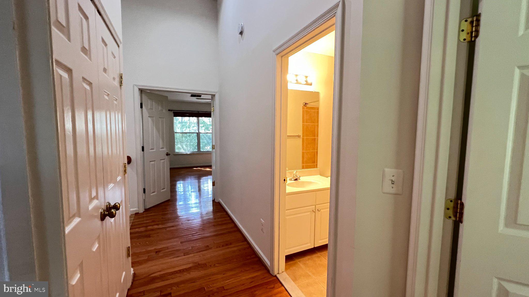 4100 Flower Fairfax, VA 22030 - Photo 24 of 47 a view of a hallway with wooden floor and a bathroom