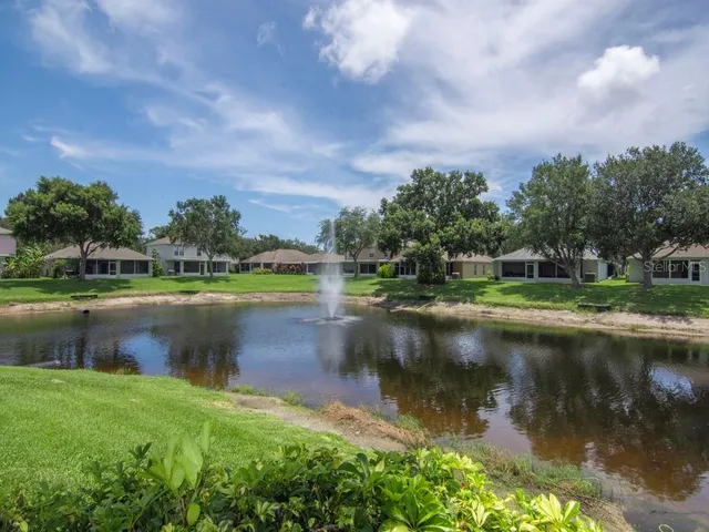 a view of a house with backyard and sitting area