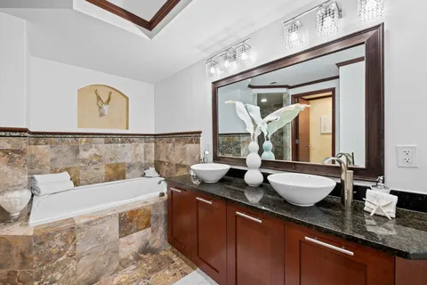 a living room with furniture and a painting on the wall