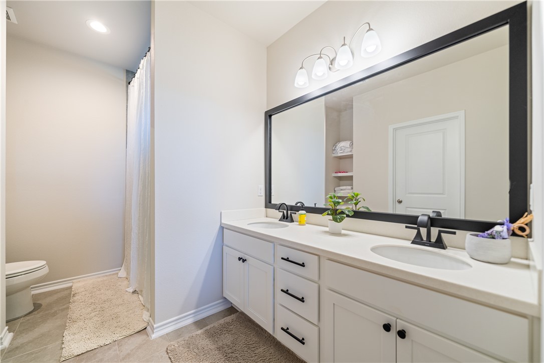 1906 Shellbank Avenue Aransas Pass, TX 78336 - Photo 13 of 27 a bathroom with a double vanity sink and a mirror