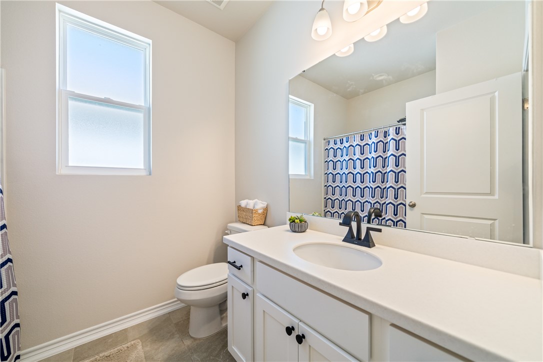 1906 Shellbank Avenue Aransas Pass, TX 78336 - Photo 19 of 27 a bathroom with a sink a toilet and shower