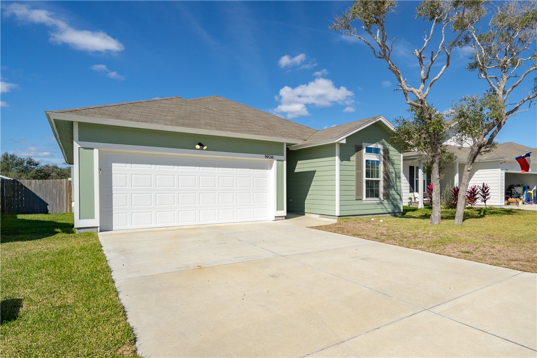 1906 Shellbank Avenue Aransas Pass, TX 78336 - Photo 2 of 27 a front view of a house with a yard and garage
