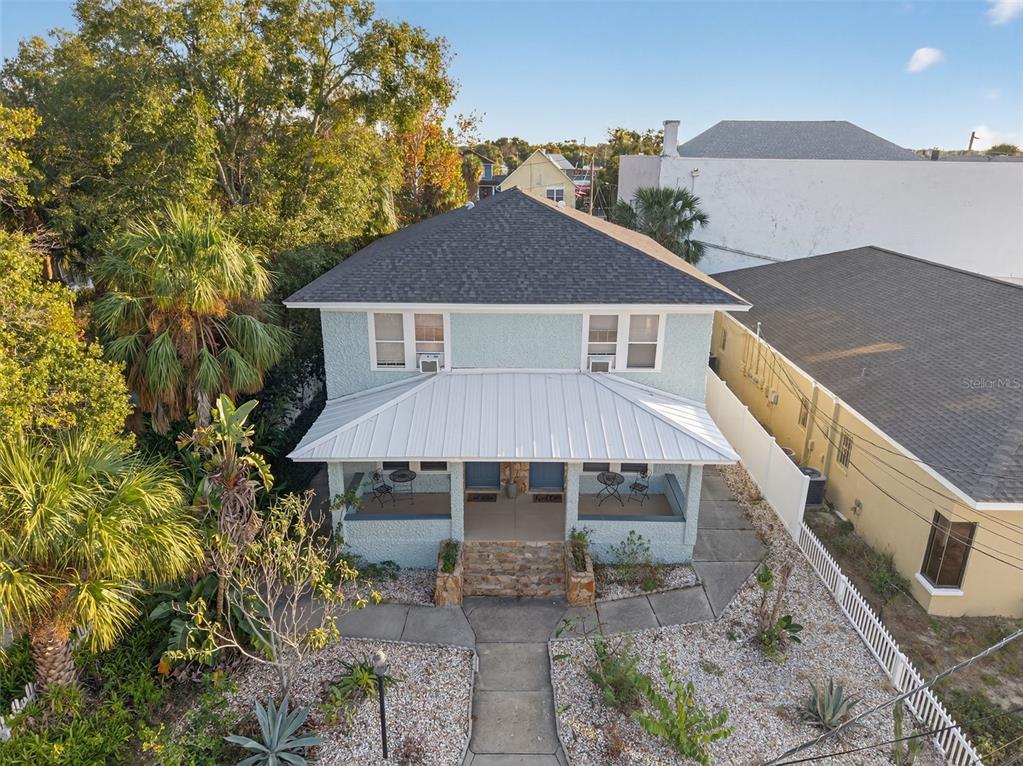 a front view of house with yard and trees in the background