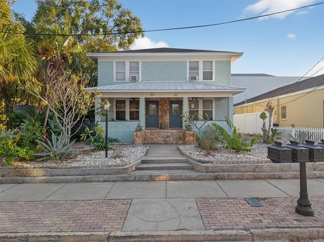 a front view of a house with a garden