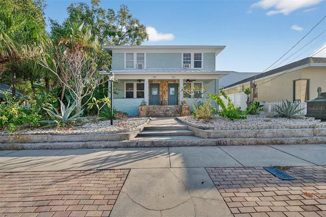 a front view of a house with garden