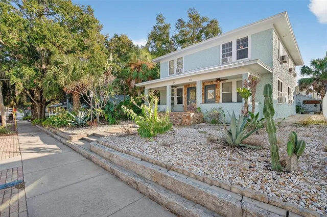 a view of a hallway with wooden floor and a living room