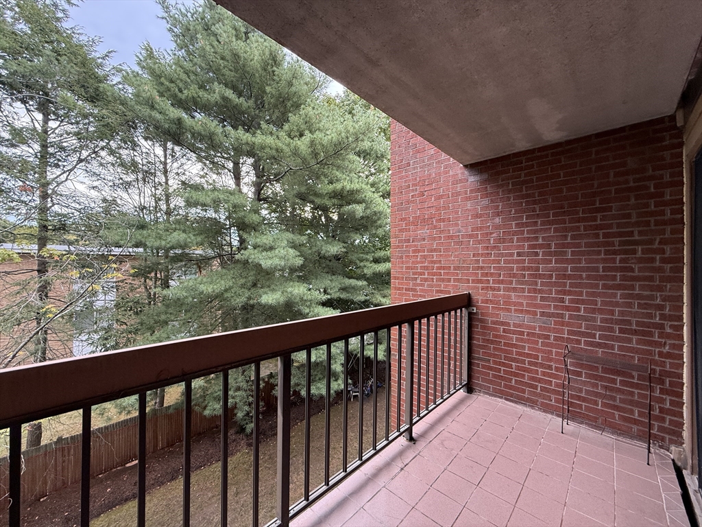 4975 Washington Street, Unit 305 Boston, MA 02132 - Photo 12 of 13 a view of a balcony with wooden fence