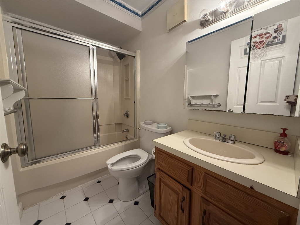 4975 Washington Street, Unit 305 Boston, MA 02132 - Photo 10 of 13 a bathroom with a sink toilet and shower