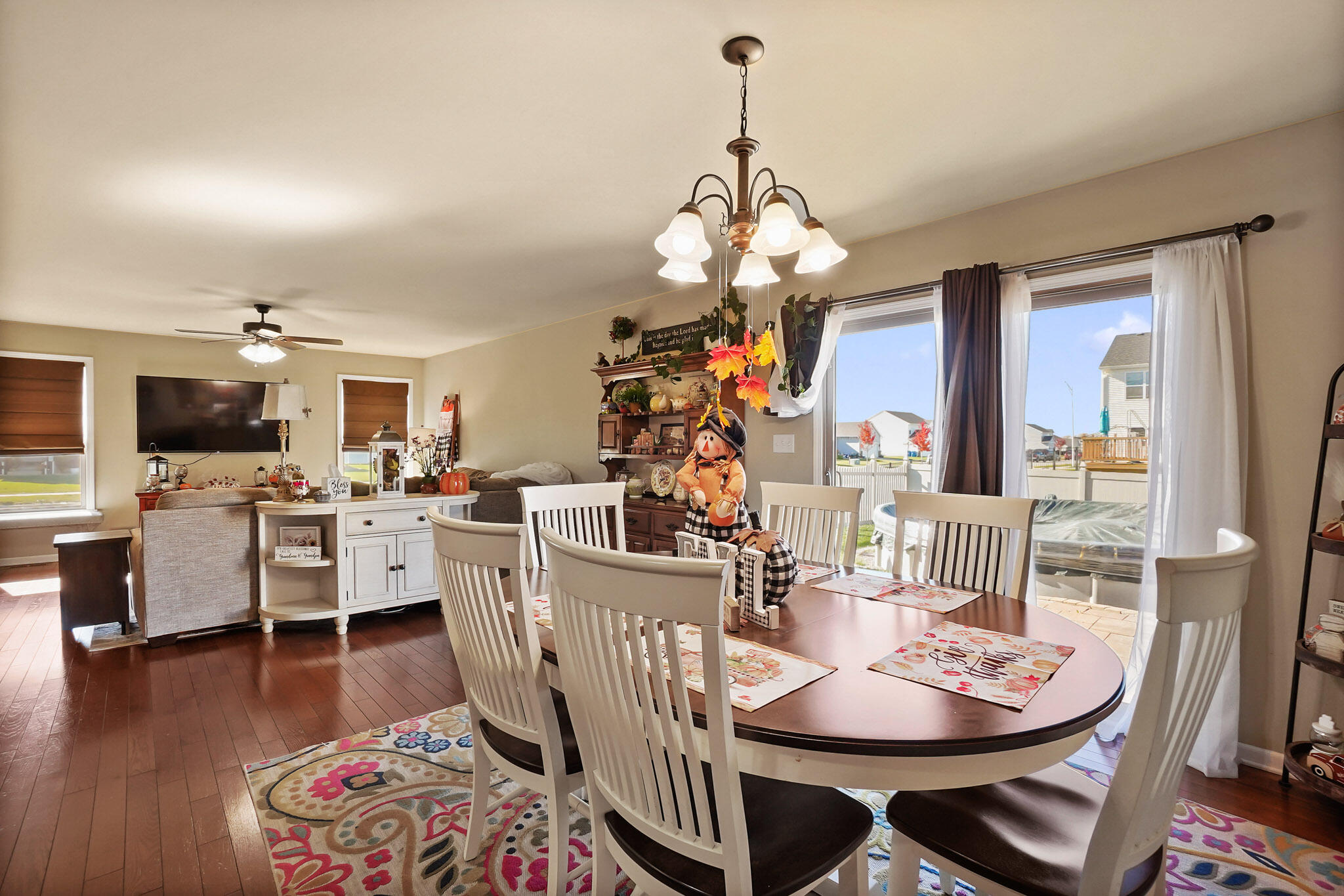 17266 Independence Drive Lowell, IN 46356 - Photo 3 of 28 a view of a dining room with furniture a chandelier and wooden floor
