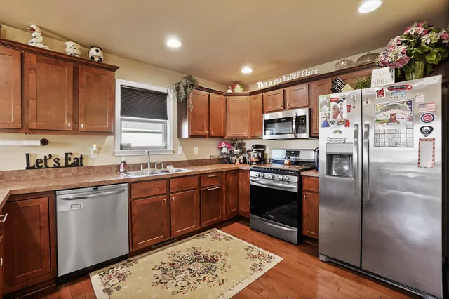a kitchen with stainless steel appliances granite countertop a refrigerator sink and cabinets