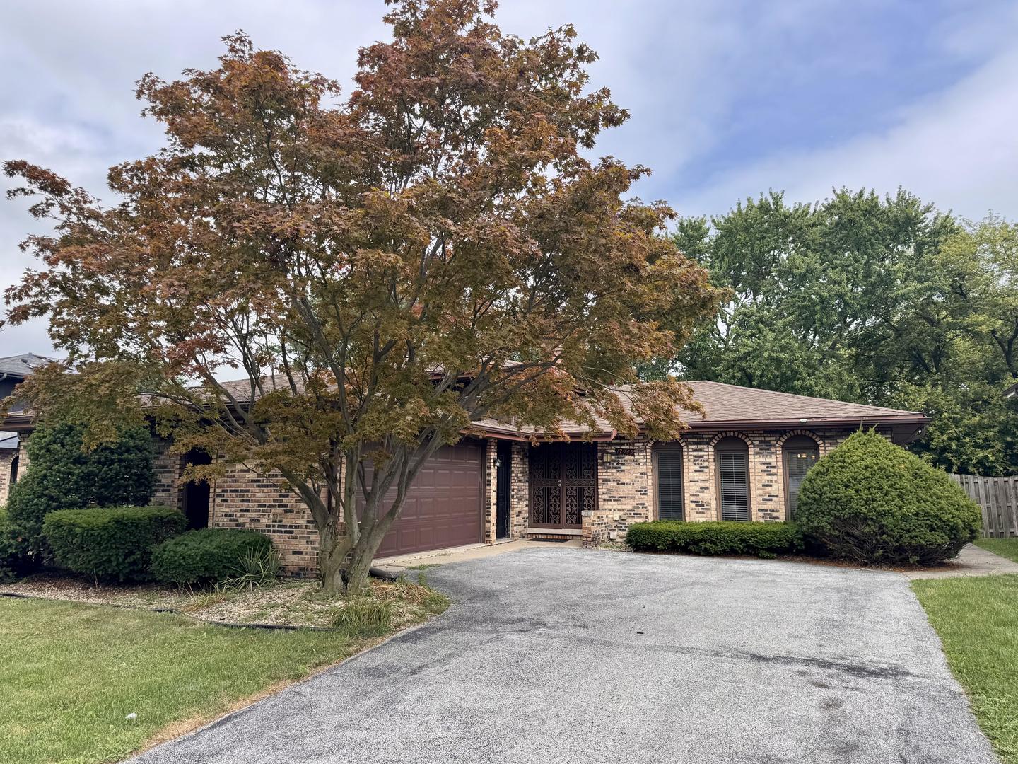17945 Maple Street Lansing, IL 60438 - Photo 1 of 33 a front view of a house with a yard