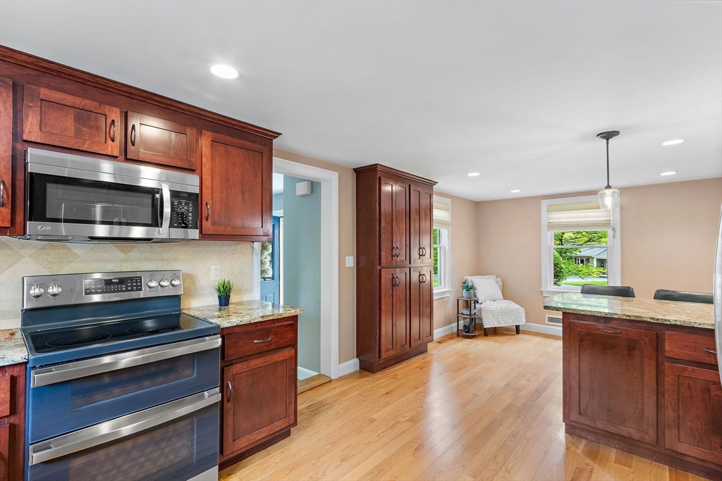 61 Pine Ridge Drive Franklin, MA 02038 - Photo 14 of 41 a open kitchen with stainless steel appliances granite countertop a refrigerator stove microwave and sink
