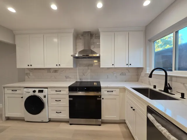 a kitchen with a stove top oven sink and cabinets