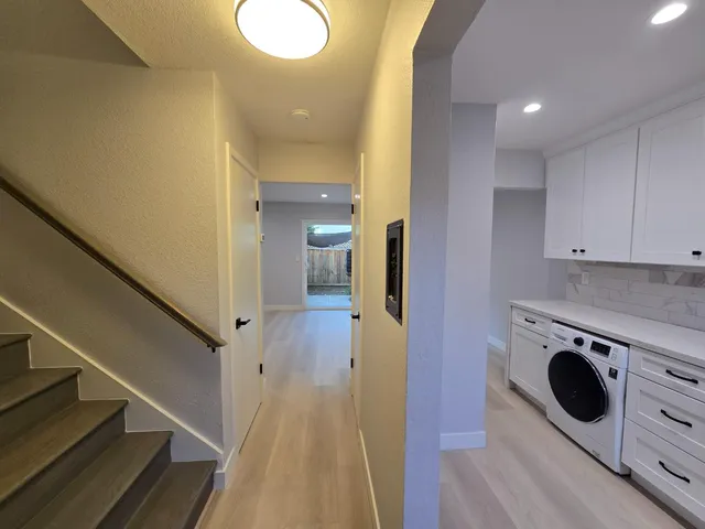 a view of a kitchen with wooden floor and electronic appliances